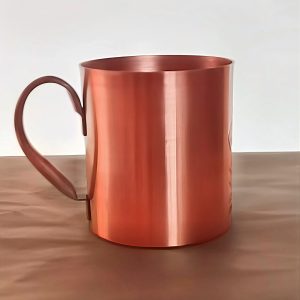 Solid Copper Mug for Hot Beverages Copper mug with handle on wooden surface, ideal for hot drinks.